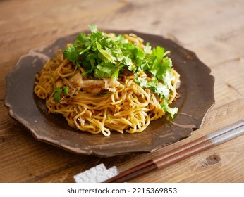 Fried Noodles Stir-fried With Chives Sauce. Cilantro On Top.