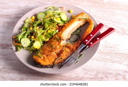 Fried Perch Fish With Salad On Plate