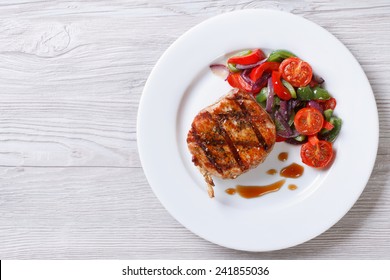 Fried Piece Of Pork With Vegetable Salad On A Plate Close-up View From Above. Horizontal 