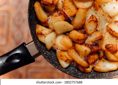 Fried Pieces Of Potato In The Pan. Harmful Food Close Up.