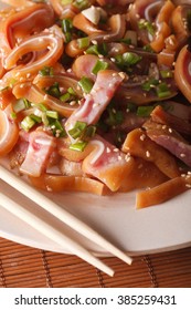 Fried Pig Ears With Sesame Seeds On A Plate Macro On The Table. Vertical
