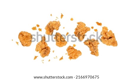 Fried popcorn chicken with crumbs isolated on white background. Top view