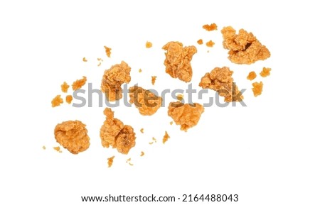 Fried popcorn chicken falling in the air isolated on white background.