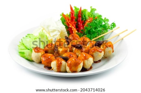 Fried Pork Balls in Skewers with Fry Chili Spicy Sauce Thai Street Food Popular decoration Vegetables and carved chili sideview
