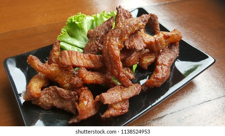 Fried pork with fish sauce is a menu that Thai people like to eat. - Shutterstock ID 1138524953