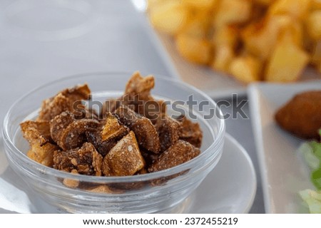 Fried pork snout in a glass bowl.