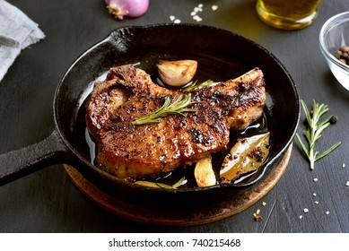 Fried pork steak in frying pan, close up view. - Powered by Shutterstock