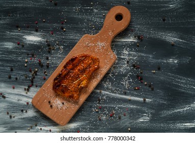 Fried pork steak on a wooden texture on a blue and white background, natural light, top view - Shutterstock ID 778000342