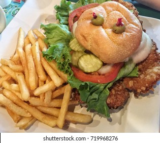 Fried Pork Tenderloin Sandwich With Fries.