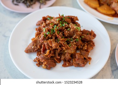 Fried Pork(Bulgogi) With Spicy Korean Sauce On A Plate