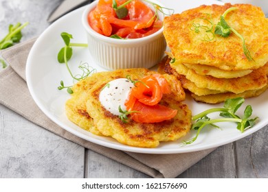 Fried Potato Pancakes With Salmon And Sour Cream, Fritter, Roesti, Golden Crispy Crust. Traditional Delicious Food, Breakfast