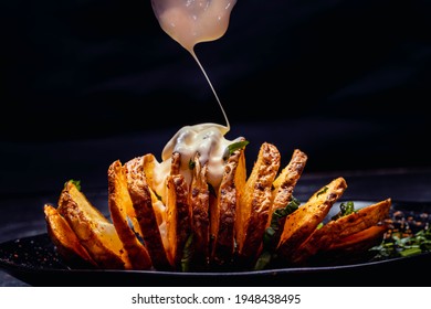 Fried Potato Spiral Tubercle On Wooden Base And Dark Background