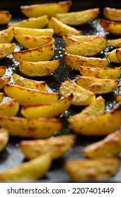 fried potato wedges on a baking sheet - Shutterstock ID 2207401449