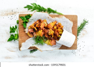 Fried potatoes with bacon. Homemade potato chips. Top view, free space for your text. Rustic style.