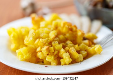 fried potatoes into small cubes on a fork