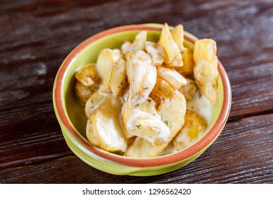 fried potatoes in a pot on a wooden table top view