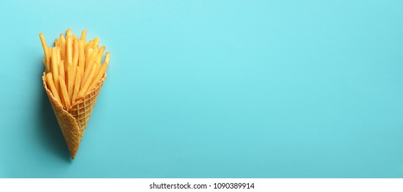 Fried Potatoes In Waffle Cones On Blue Background. Hot Salty French Fries With Tomato Sauce. Fast Food, Junk Food, Diet Concept. Top View. Minimal Style. Pop Art Design, Creative Concept.