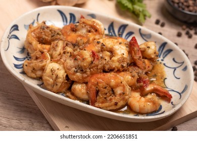 Fried prawns with black pepper and garlic in a white plate - Powered by Shutterstock