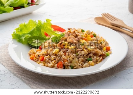 Fried Rice with canned Tuna fish.Quick and Easy Thai style spicy one dish meal on white plate