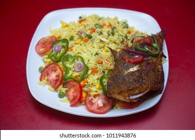 Fried Rice And Fried Fish. Popular Nigerian Food/Dishes/Cuisine.