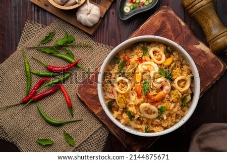 Fried rice with shrimp ,green Mussels and squid with thai holy basil .Top view