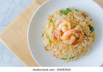 Fried Rice With Shrimp On The White Dish On Wooden Table From Top View