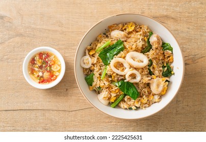 Fried rice with squid or octopus in bowl - stir-fried rice with squid, egg and kale - Shutterstock ID 2225425631