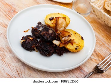 Fried rustic tasty blood sausage with potato served at plate, nobody