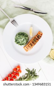 Fried Salmon Steak Fillet Mash Potato Top View. Grilled Fish And Lemon Slice On White Plate Flatlay. Barbecue Food With Fresh Vegetable Spinach Cuisine. Healthy Lunch Gourmet Overhead With Copy Space