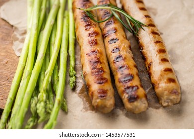 Fried sausages on a craft paper on wooden serving Board. Concept of healthy food. - Shutterstock ID 1453577531