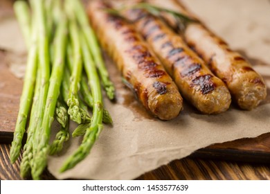 Fried sausages on a craft paper on wooden serving Board. Concept of healthy food. - Shutterstock ID 1453577639
