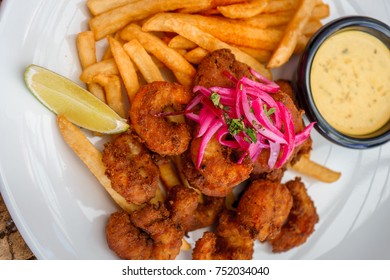 Fried Seafood Platter With Fish, Shrimp, Oysters, Hush Puppies, And A Crab Cake.