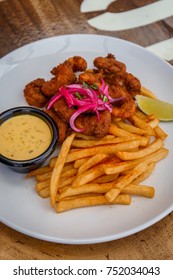 Fried Seafood Platter With Fish, Shrimp, Oysters, Hush Puppies, And A Crab Cake.