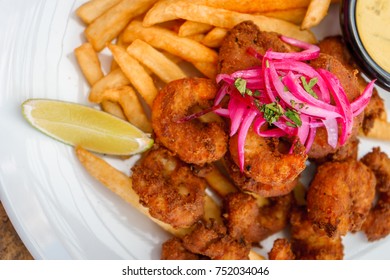 Fried Seafood Platter With Fish, Shrimp, Oysters, Hush Puppies, And A Crab Cake.