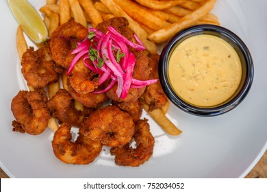 Fried Seafood Platter With Fish, Shrimp, Oysters, Hush Puppies, And A Crab Cake.