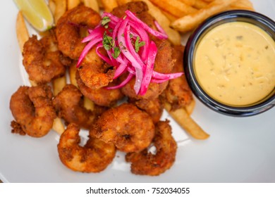 Fried Seafood Platter With Fish, Shrimp, Oysters, Hush Puppies, And A Crab Cake.