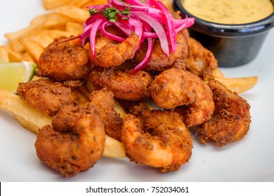 Fried Seafood Platter With Fish, Shrimp, Oysters, Hush Puppies, And A Crab Cake.