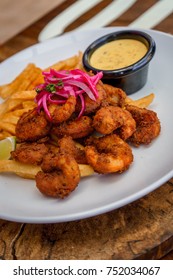 Fried Seafood Platter With Fish, Shrimp, Oysters, Hush Puppies, And A Crab Cake.