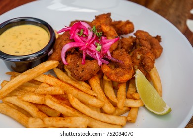 Fried Seafood Platter With Fish, Shrimp, Oysters, Hush Puppies, And A Crab Cake.