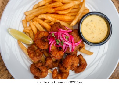 Fried Seafood Platter With Fish, Shrimp, Oysters, Hush Puppies, And A Crab Cake.