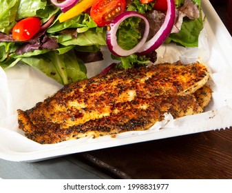 Fried And Seasoned Fish With Salad