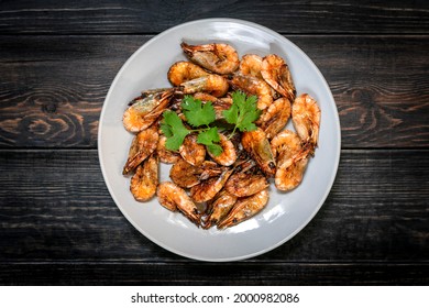 Fried Shrimp With Soy Sauce, Garlic In Gray Plate On Wooden Table Seafood Traditional Thai Food