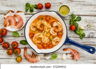 Fried shrimp with tomatoes and garlic. Mediterranean food.