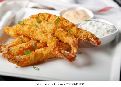 Fried shrimps on sticks in crispy coating with sauce
