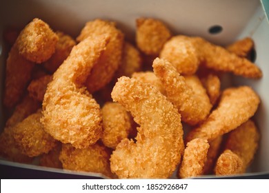 Fried shrimps in white striped fast food box