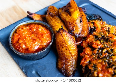 Fried slices of ripe plantain and chilli sauce eaten as snack or a dishes in Nigerian, African and South American countries  plantain slice. Platanos Maduros