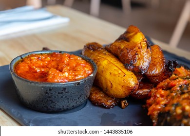 Fried Slices Of Ripe Plantain And Chilli Sauce Eaten As Snack Or A Dishes In Nigerian, African And South American Countries  Plantain Slice. Platanos Maduros