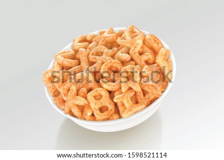 Fried and Spicy ABCD, Alphabet Snacks or Fryums (Snacks Pellets) served in a white bowl. selective focus - Image
