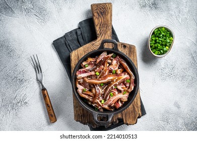 Fried Spicy Pork Pig Ears Served In A Frying Pan. White Background. Top View.