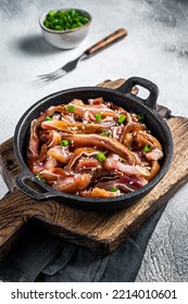 Fried Spicy Pork Pig Ears Served In A Frying Pan. White Background. Top View.